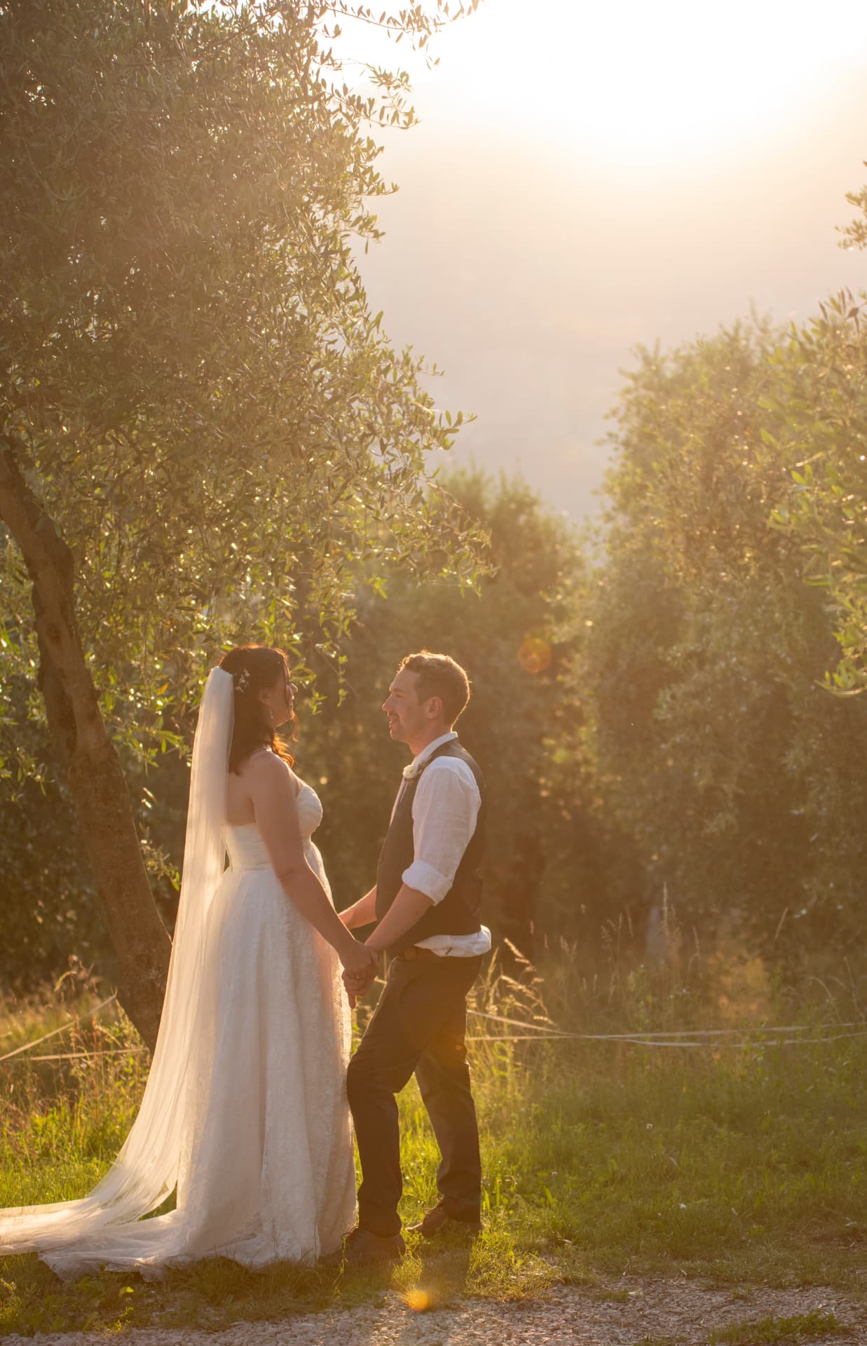 Bride and groom kissing in front of a rustic Italian door