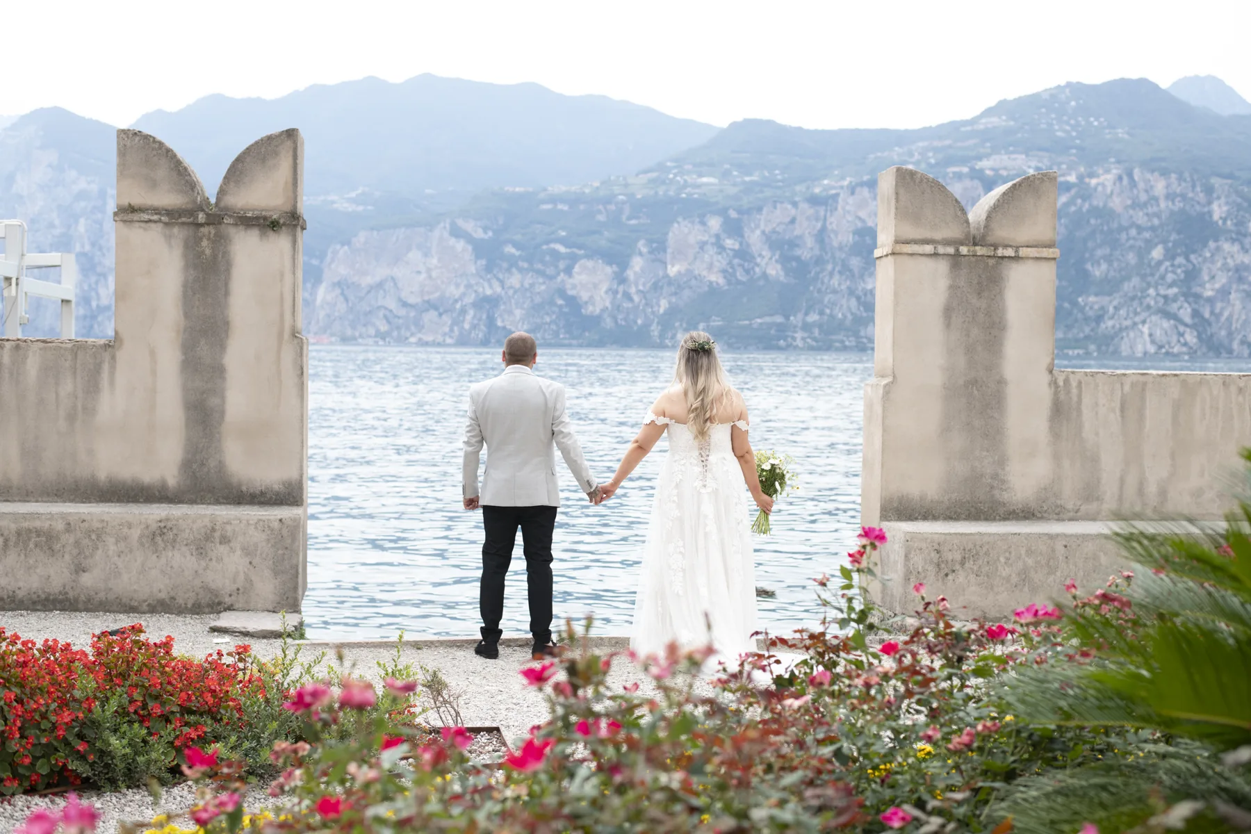 A couple on the castle walls looking out across Lake Garda