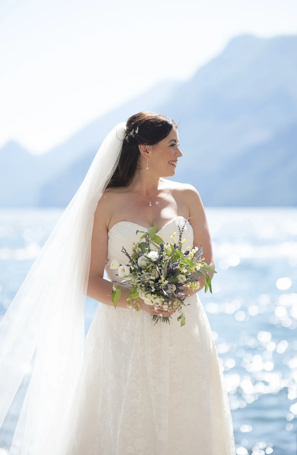 A bride in her veil with Lake Garda behind her