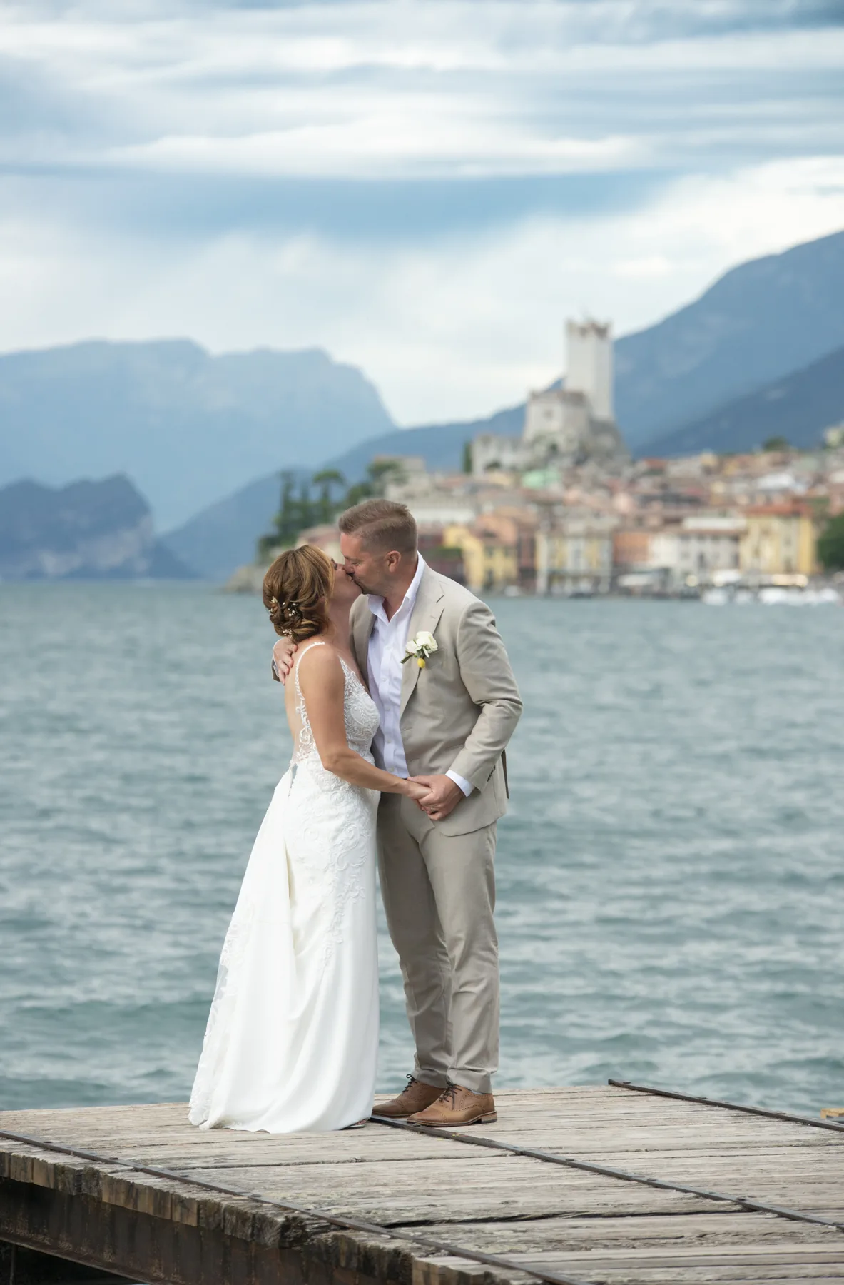A couple on a jetty as the light softens over the lake