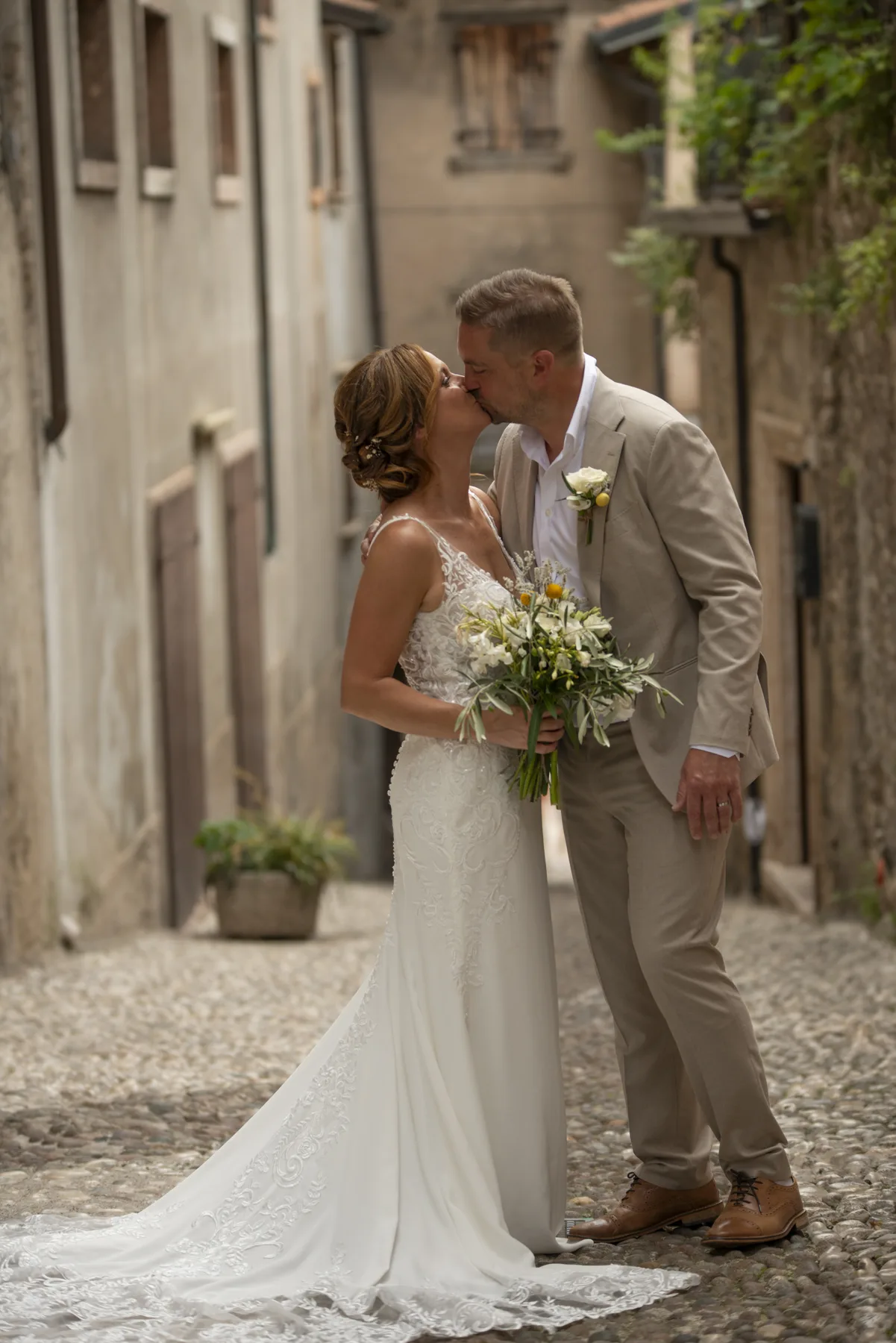 A couple kissing in a quiet Italian side street