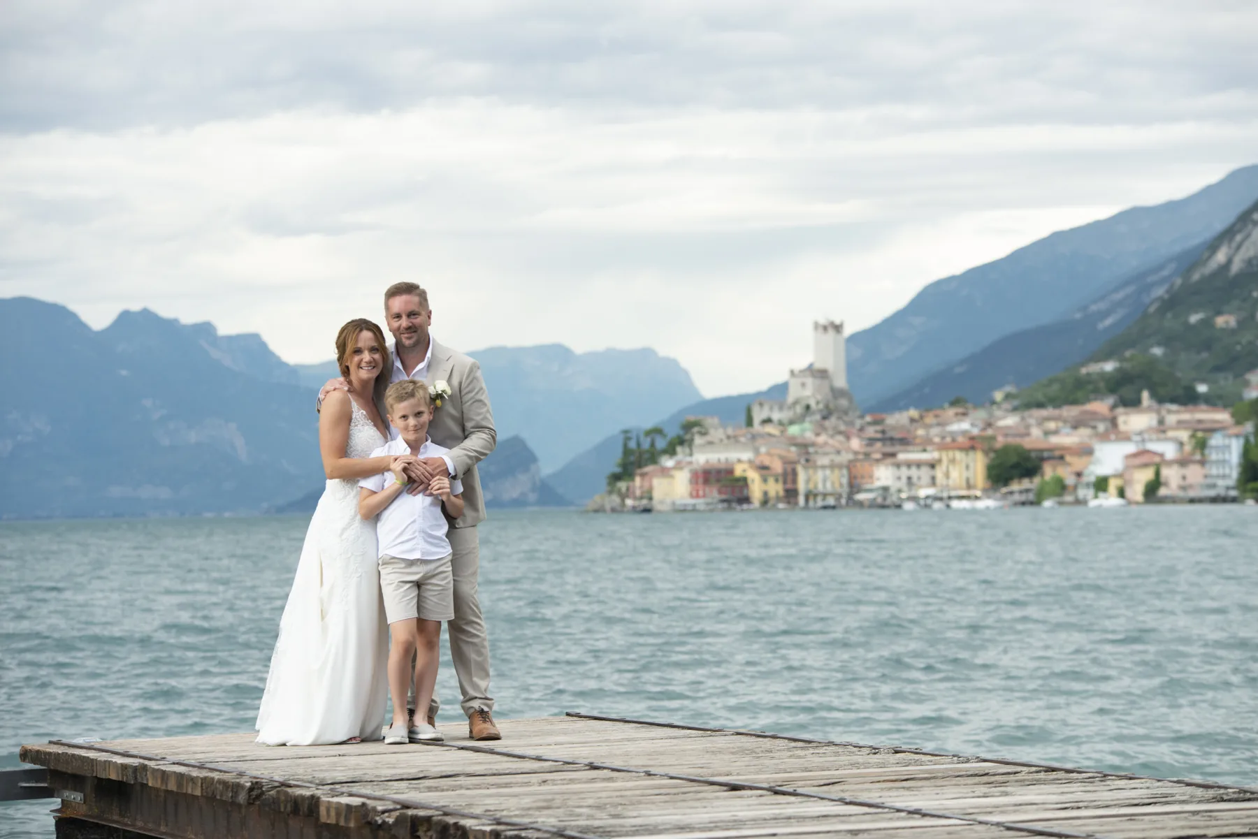 A family together on a jetty on Lake Garda