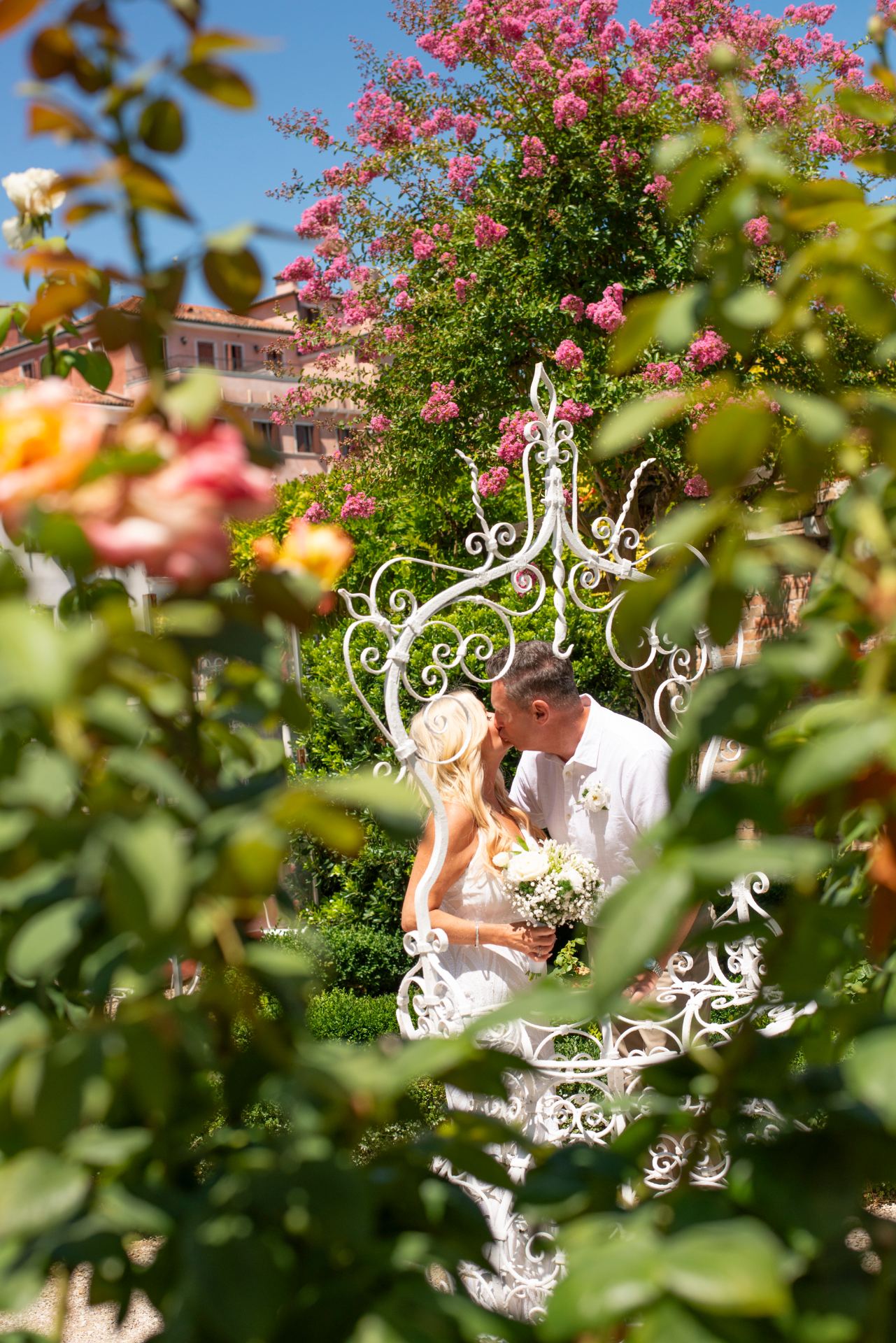 A newlywed couple sharing a quiet moment in a garden