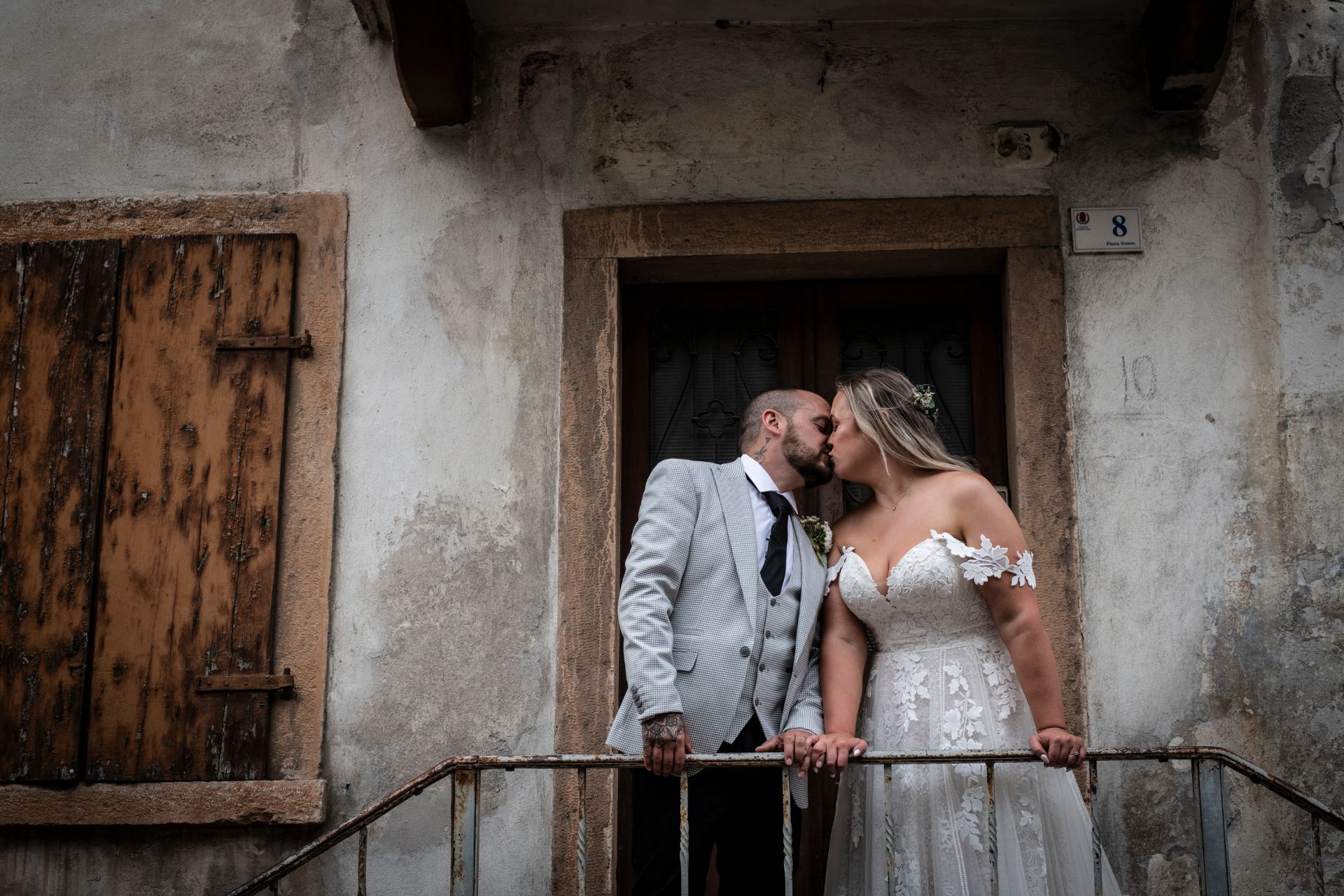A bride and groom sharing a first kiss as newlyweds