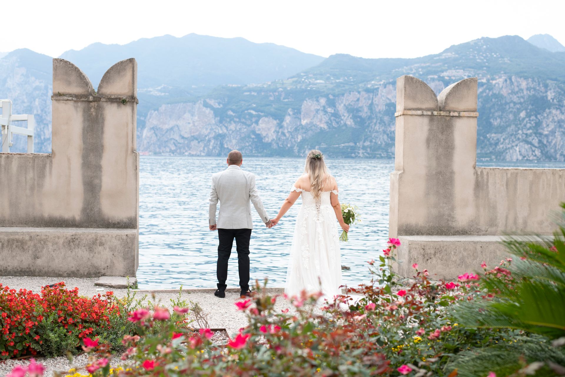 A couple watching the sun set over Lake Garda
